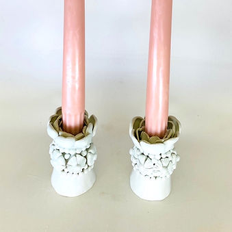 A pair of handcrafted porcelain candle holders
